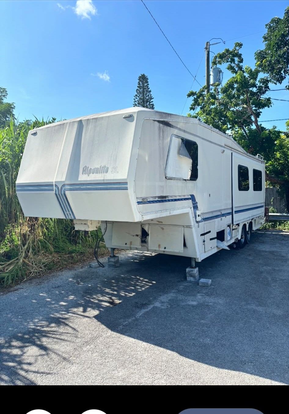 The Alpenlite fifth wheel as purchased, white with blue stripes