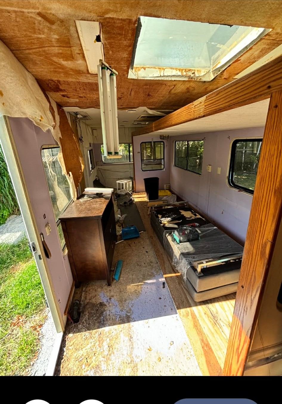 Gutted RV interior showing damaged skylight