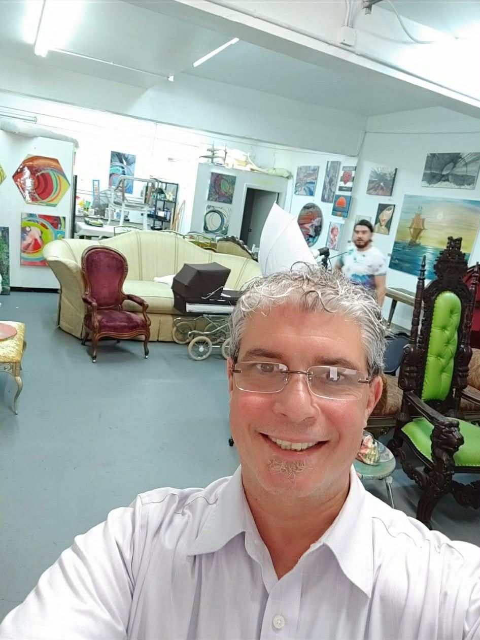 Wide view of the studio with canvases covering the walls